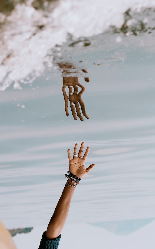 an image of hand and its reflection in water